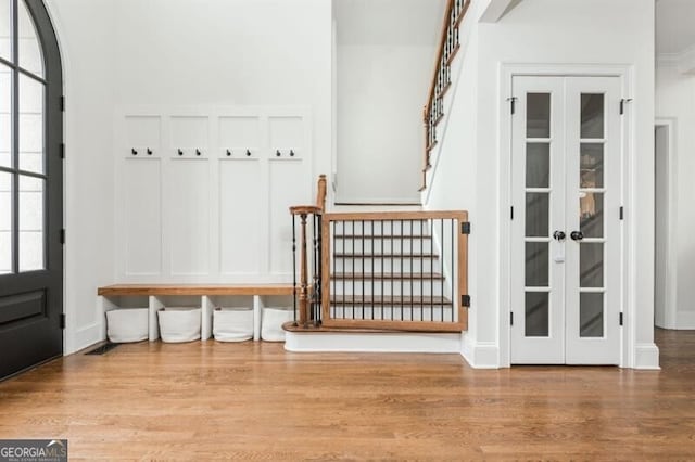 mudroom featuring french doors and light hardwood / wood-style floors