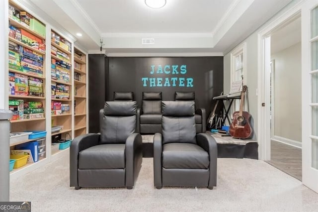 home theater featuring ornamental molding and carpet flooring