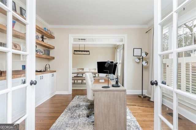 office area featuring french doors, ornamental molding, and hardwood / wood-style flooring