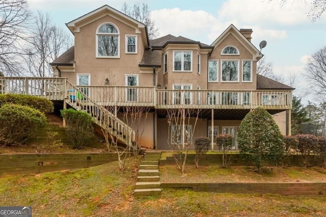 back of house with a wooden deck