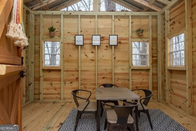 sunroom / solarium featuring vaulted ceiling