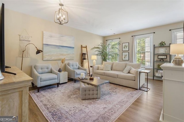 living room with a chandelier and hardwood / wood-style floors