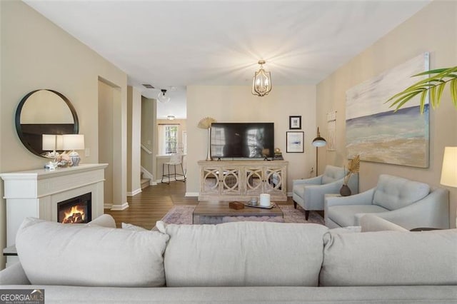 living room with an inviting chandelier and hardwood / wood-style floors