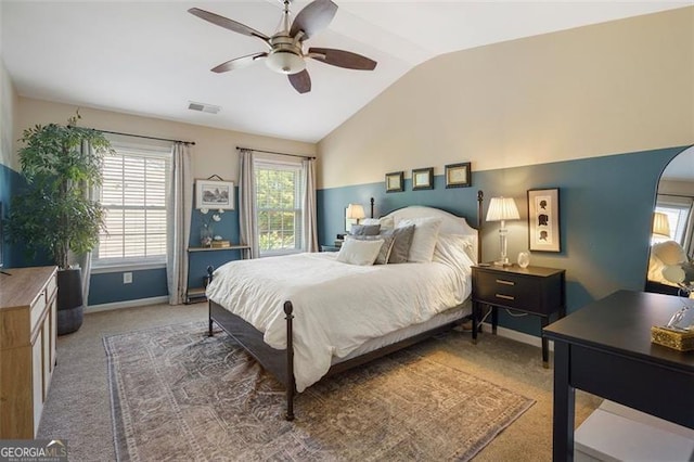 carpeted bedroom with vaulted ceiling and ceiling fan