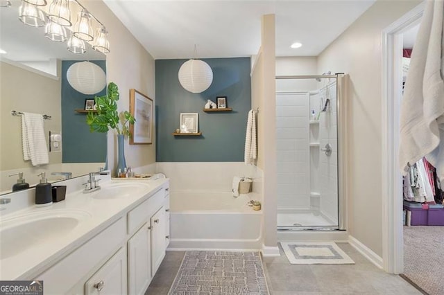 bathroom with vanity and shower with separate bathtub