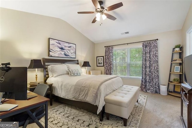 bedroom with light carpet, vaulted ceiling, and ceiling fan