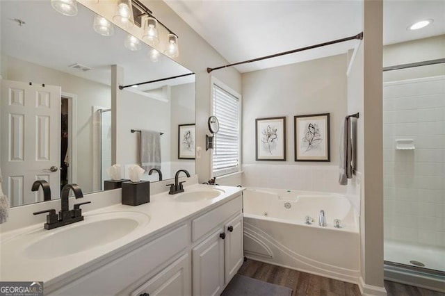 bathroom featuring wood-type flooring, separate shower and tub, and vanity