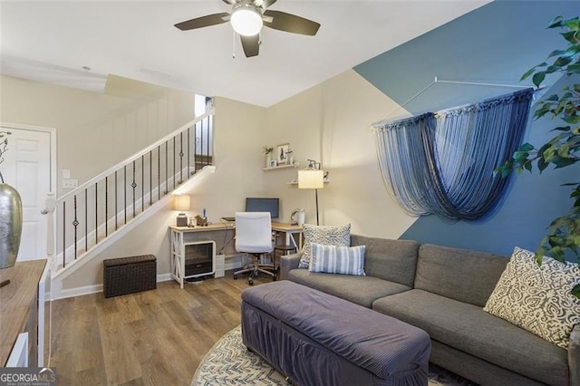 living room with wood-type flooring and ceiling fan