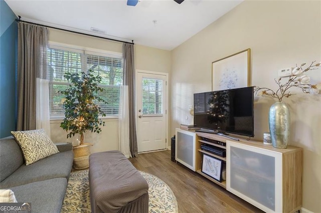 living room with dark wood-type flooring and ceiling fan