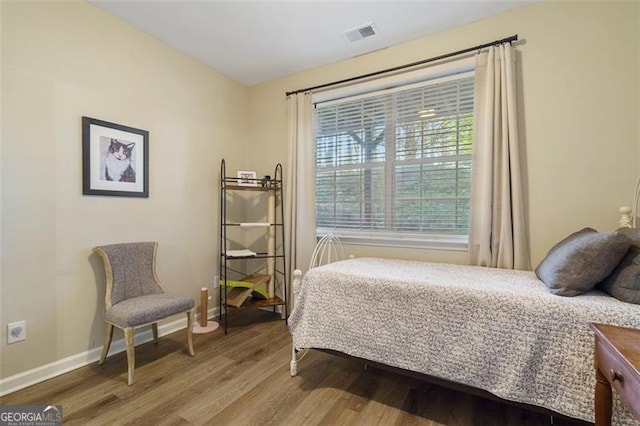 bedroom with hardwood / wood-style flooring