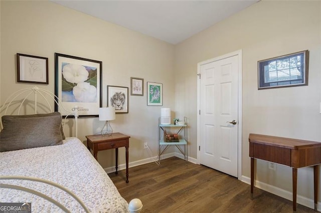 bedroom with dark hardwood / wood-style floors