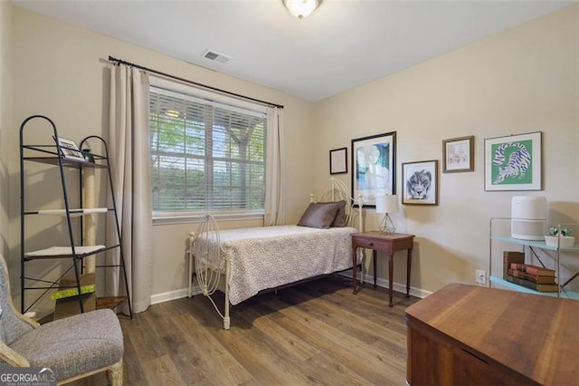 bedroom with hardwood / wood-style flooring