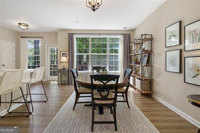 dining space featuring a chandelier and dark hardwood / wood-style flooring