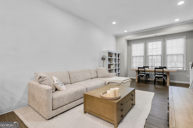 living room featuring hardwood / wood-style flooring and crown molding