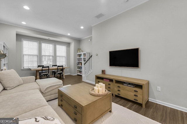 living room featuring crown molding and hardwood / wood-style flooring