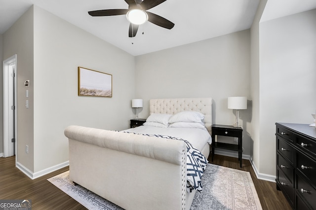 bedroom with dark hardwood / wood-style flooring and ceiling fan