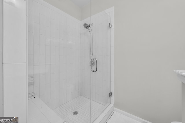 bathroom with a shower with shower door