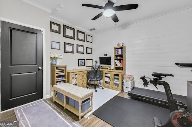 home office with hardwood / wood-style flooring, ceiling fan, and ornamental molding