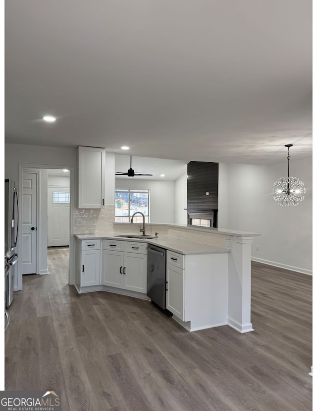 kitchen featuring pendant lighting, sink, appliances with stainless steel finishes, tasteful backsplash, and white cabinets