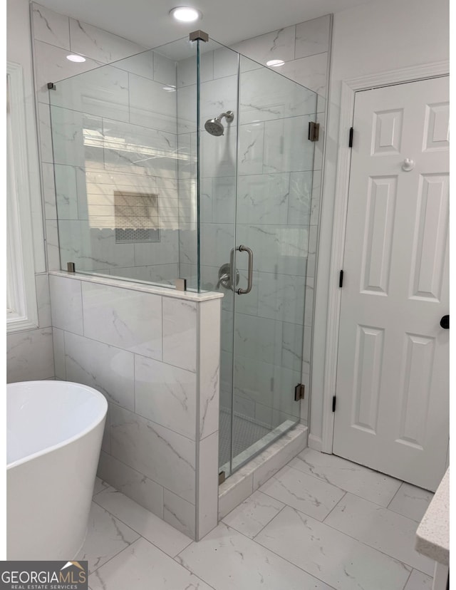 bathroom with shower with separate bathtub