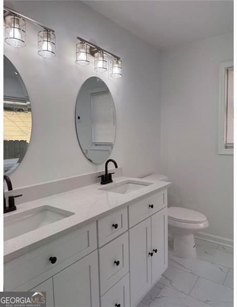 bathroom featuring vanity and toilet