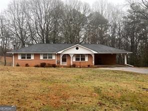 ranch-style house with a carport and a front yard