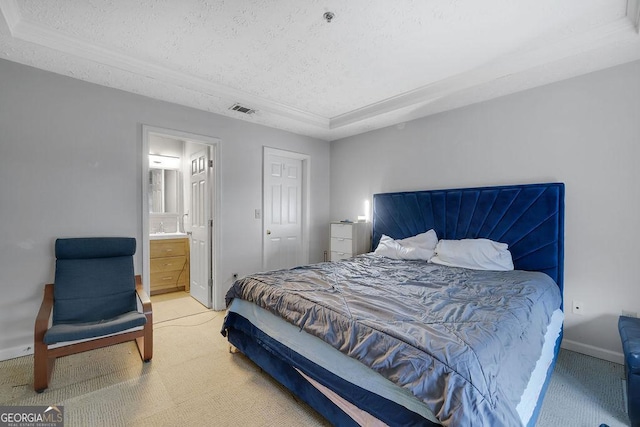 bedroom featuring a tray ceiling, visible vents, light carpet, and a textured ceiling