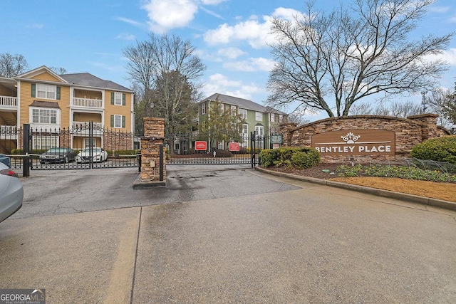 view of road with a gated entry and curbs