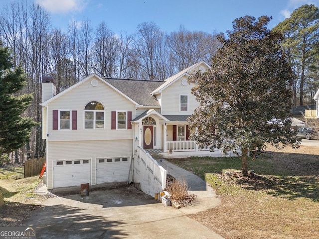 view of front facade with a garage and a porch