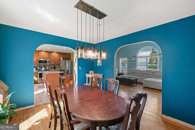 dining space with light hardwood / wood-style flooring