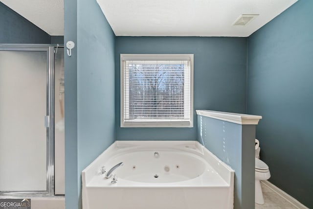 bathroom with toilet, shower with separate bathtub, and a textured ceiling