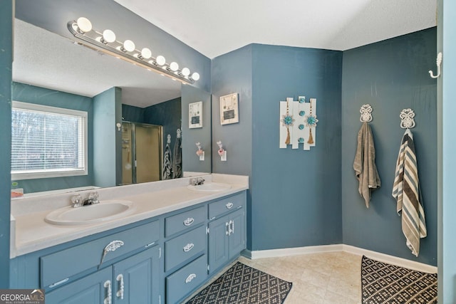 bathroom featuring a shower with door and vanity