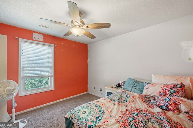 bedroom featuring ceiling fan, carpet floors, and a textured ceiling