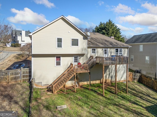 back of property with a wooden deck and a yard