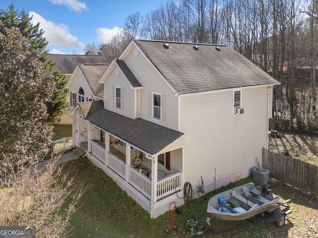 back of house with central air condition unit and a porch