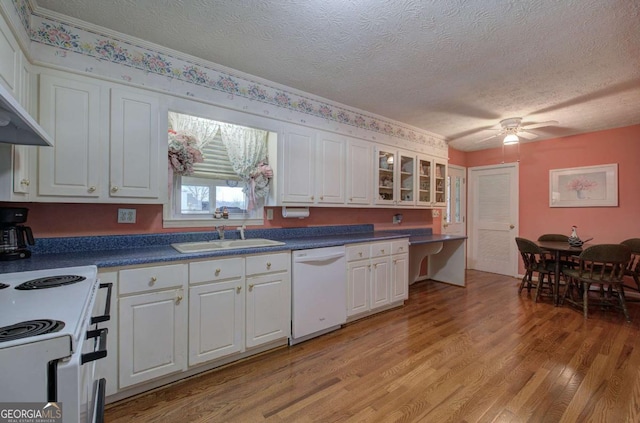 kitchen featuring white cabinetry, sink, a textured ceiling, and white appliances