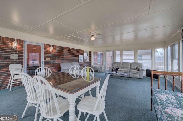 sunroom featuring ceiling fan