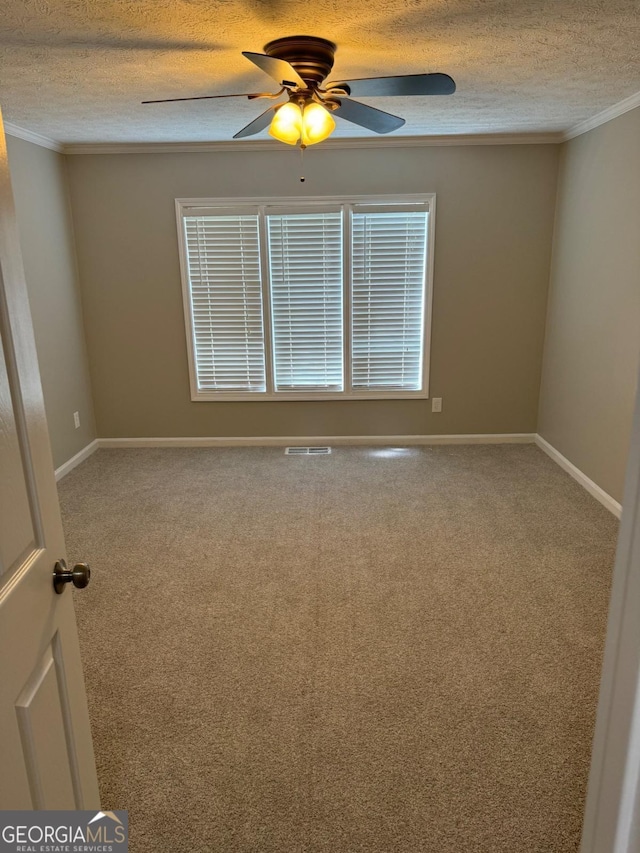 unfurnished room with ceiling fan, ornamental molding, and a textured ceiling