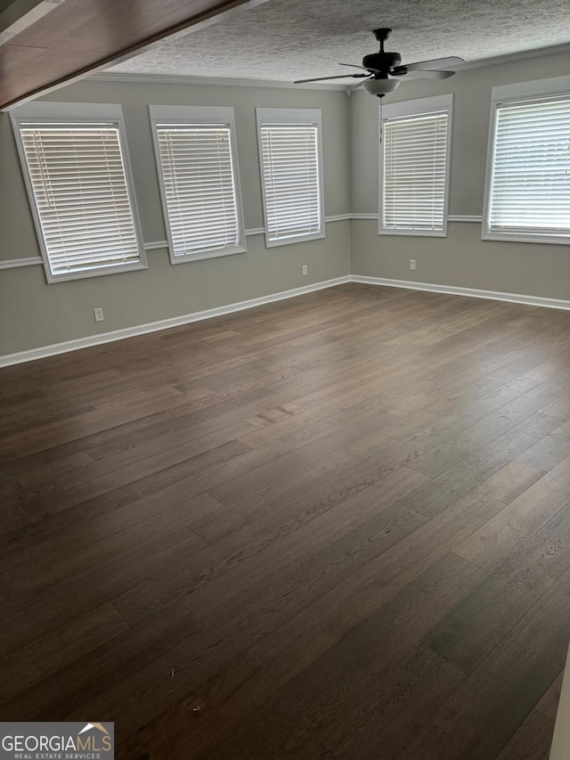 spare room with dark hardwood / wood-style flooring, a textured ceiling, and ceiling fan