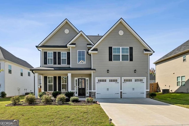 view of front of property with cooling unit, a porch, a garage, and a front lawn