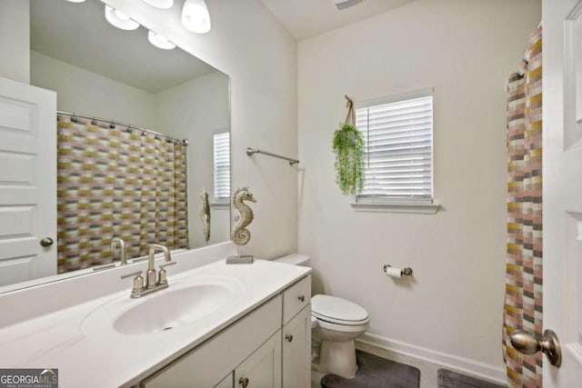 bathroom with tile patterned flooring, vanity, and toilet