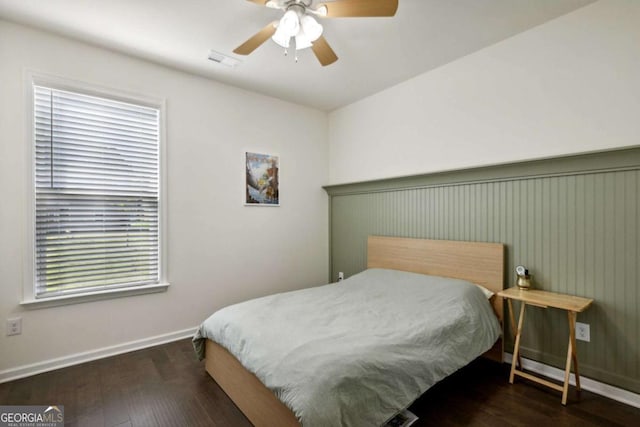 bedroom with dark wood-type flooring and ceiling fan