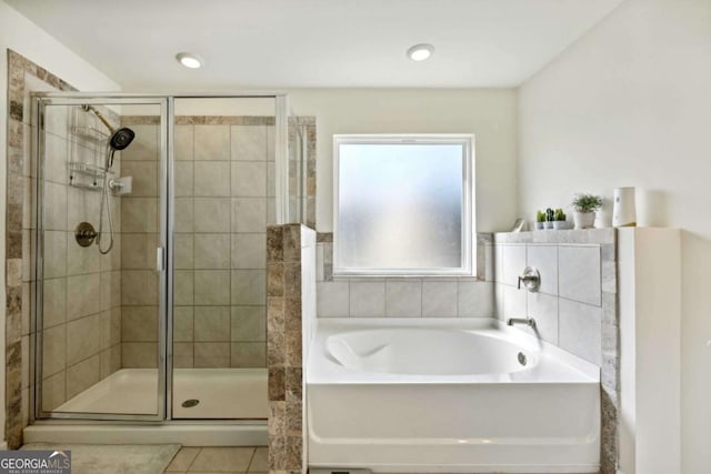 bathroom with shower with separate bathtub and tile patterned flooring