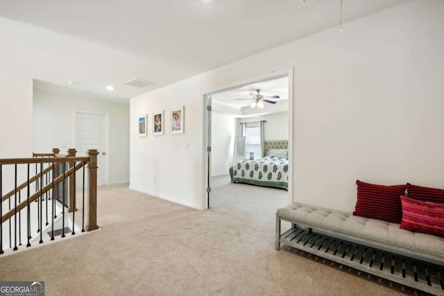 hallway featuring light carpet