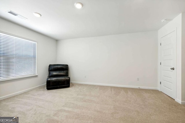 unfurnished room with a wealth of natural light and light colored carpet