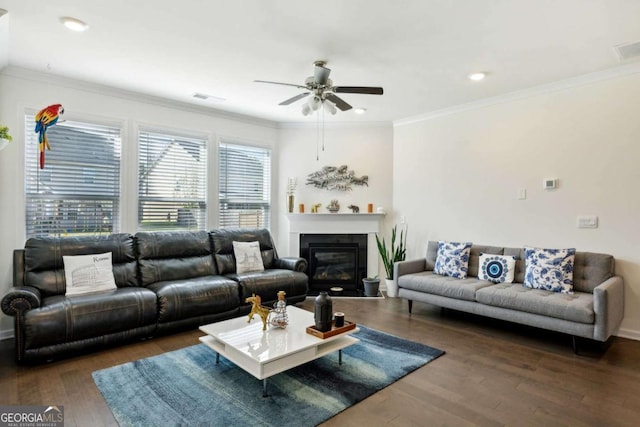 living room featuring dark wood-type flooring, ceiling fan, and crown molding