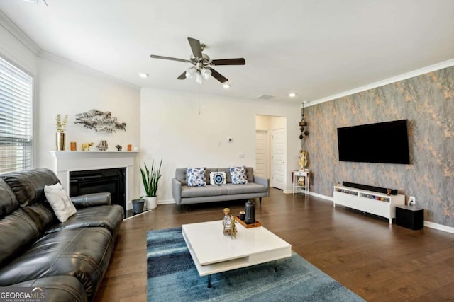 living room featuring dark wood-type flooring, ornamental molding, and ceiling fan