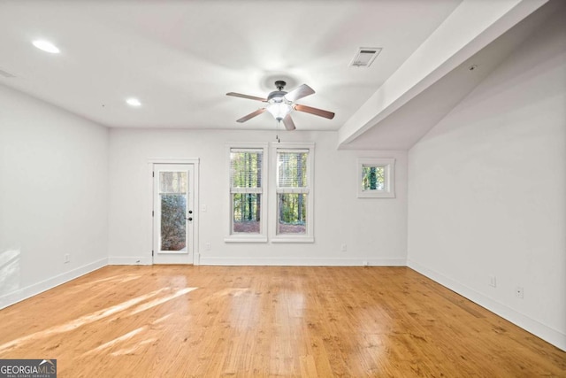 spare room with ceiling fan and light wood-type flooring