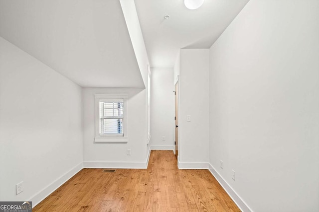 additional living space with light hardwood / wood-style floors