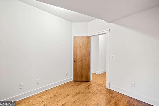 spare room with wood-type flooring